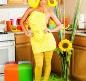 Gal in yellow pantyhose pokes her pussy with a green zucchini at the kitchen.