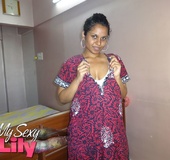 Foxy Indian babe posing in her pink, blue and white dress before she opens