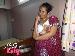 Foxy Indian babe posing in her pink, blue and white dress before she opens it and expose her alluring boobs with big nipples under her white bra. - XXXonXXX - Pic 11