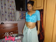 Luscious Indian hottie displays her chubby body before she opens her hanging blue blouse and reveals her big soft breasts then pulls down her white skirt and expose her huge juicy butt in her bedroom.