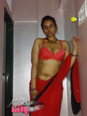 Stunning Indian chick displays her hot curves in red and black dress before she pulls it down and bares her hot tits with big nipples under her red bra on a gray and white bed. - XXXonXXX - Pic 6