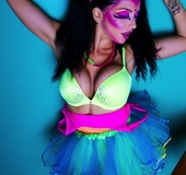 Naughty chick with colorful make-up wearing multi-colored outfit and mint
