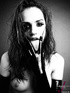 Nasty babe shows her hot tits while smoking a cigarette wearing her black