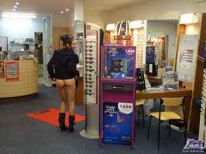 Pretty trick in a black dress and coat flashes at an optical shop. - XXXonXXX - Pic 8