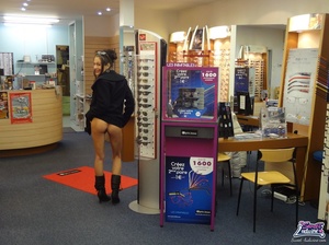 Pretty trick in a black dress and coat flashes at an optical shop. - XXXonXXX - Pic 9