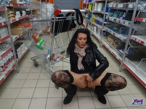 Wicked skank in a black jacket and stockings does some carrots at the checkout counter. - Picture 2