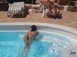 Elegant nude girlie in sunglasses touches her twat at the pool. - Picture 11