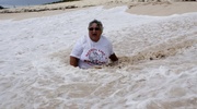 Mature babe posing on the beach then opens her legs wide and reveals her crack before she lifts up her white big cock shirt and display her big soggy breasts.