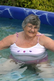 Gorgeous granny gets her big body wet in a pool wearing her white shirt and pink shorts then expose her big soggy breasts.