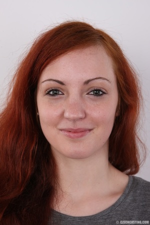 Attractive red-haired tramp in a grey to - Picture 1