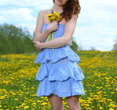 Loose tramp in a frilly blue dress shows her bush on a field of yellow