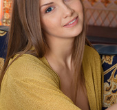 Dreamy fawn gets out of her golden sweater at the living room.