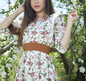 Superb firecracker ditches her floral dress under a tree with white flowers.