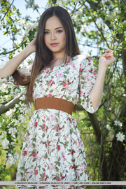 Superb firecracker ditches her floral dress under a tree with white flowers.