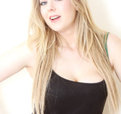 Raunchy girl in a plaid skirt, black top and green lingerie reveals her