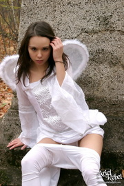 Stunning hottie pose her skinny young body wearing her white angel dress with wings then she pulls down her pants and display her hot booty under her white thong.