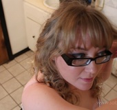 Hot babe with black glasses puts on her make up in white nighty with pink