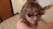 Hot babe with black glasses puts on her make up in white nighty with pink polka dots before she irons her golden hair.