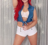 Smoking hot redhead takes off her blue shirt and white shorts then displays