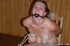 Cutie with gag in her mouth is tied with ropes to the chair