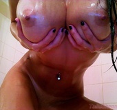 Stunning brunette expose her huge breasts as she takes a shower while