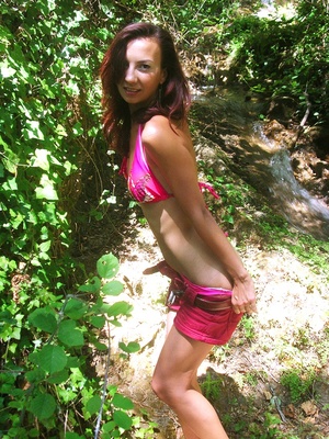 Gorgeous hottie strips down her pink shorts then allures with her smoking hot body in pink floral bikini before she takes off her bra and reveals her small tits in a forest. - XXXonXXX - Pic 2