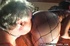 Red-haired Ebony in fishnet bodystocking gives feet for licking