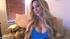 Horny busty blonde in blue dress strips nude on couch to reveal tits,