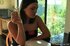 Sexy young darling likes to smoke in the kitchen so much