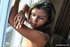 Attractive young lady shows her body and smokes with pleasure