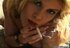 Blonde bombshell smokes a cigarette on the couch