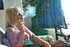 Gorgeous blonde bombshell on a couch loves to smoke