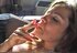 Beautiful lady displays her body and puffs on a cigarette