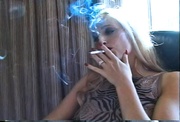 Mean blonde bitch shows her tits and smokes a cigarette