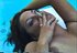 Fine babe with huge titties smokes by the pool