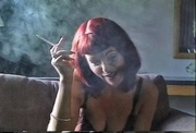 Sexy redhead teasing her kitty while she smokes with joy
