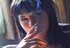 Stunning raven haired gal in stockings smoking with joy