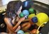Black gal plays with balloons in the jacuzzi