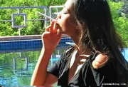 Asian lady enjoying a sunny day with a cigarette