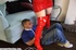 Hot bitch in red costume dominates poor bondaged boy