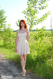 Stunning hottie shows her hot tits on the road by a green field while she peels off her white dress before she strips down her white thong and shows her indulging pussy wearing her white shoes.