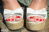 Blonde bombshell in white blouse and white and brown high heels displays