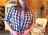 Stunning redhead opens her black and white checkered polo then shows her