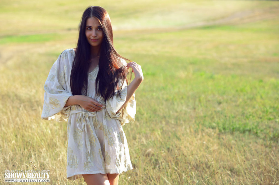 Beautiful teen brunette goes out in a green field then slowly peels off her white robe and bares her sweet boobs and skinny body before she seduces with her indulging pussy in different positions. - XXXonXXX - Pic 1