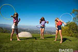 Three teens play with Hula Hup before le - Picture 1