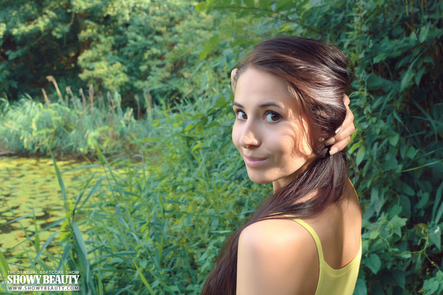 Gorgeous young chick with luscious thin body removes her yellow shirt and bares her hot boobs before she shows her crack in different positions while she pose naked by the lake. - XXXonXXX - Pic 1