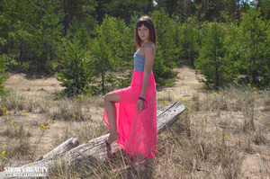 Teen brunette wearing blue tube top and pink skirt reveals her sweet tits and indulging pussy before she pulls down her pink panty and expose her alluring pussy before she gets naked and seduces with her slim body on a big log by the lake. - XXXonXXX - Pic 1