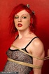 Redhead hottie gets tied and sucks a black dildo
