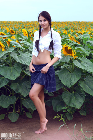 Pig tailed young gal posing outdoors among sunflowers - XXXonXXX - Pic 2