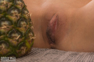 Slender teen girl posing with a big pineapple - Picture 5
